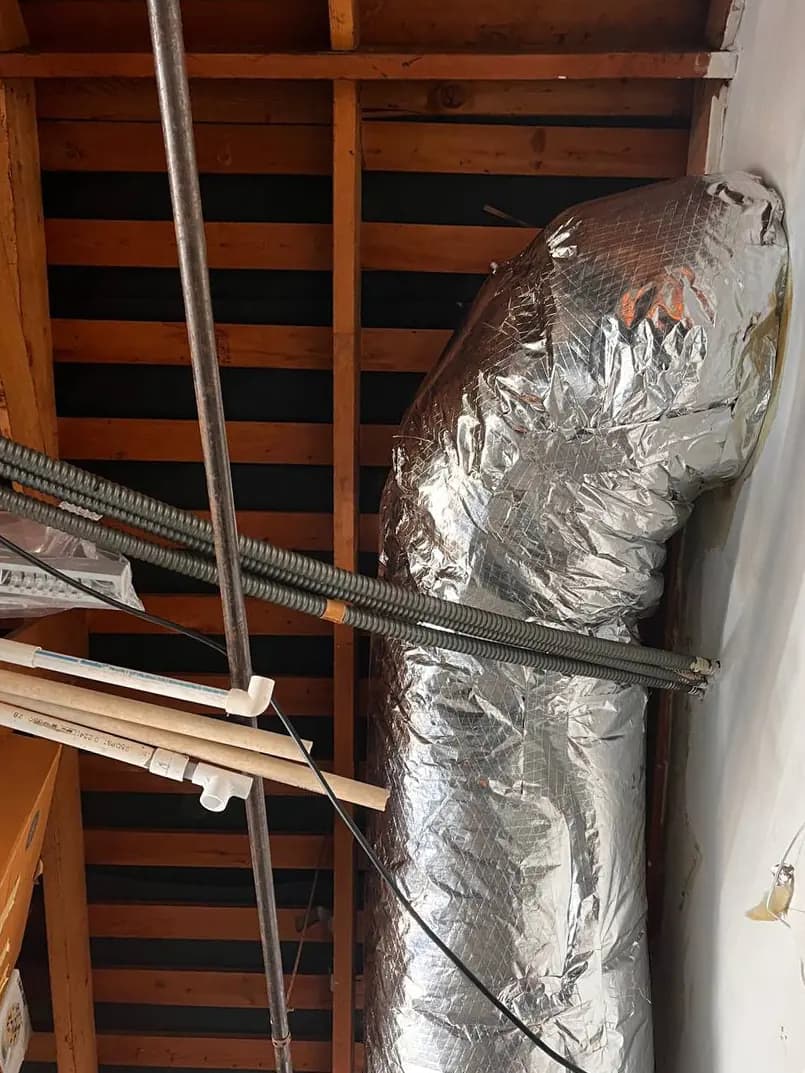 Insulated flexible air duct in an attic