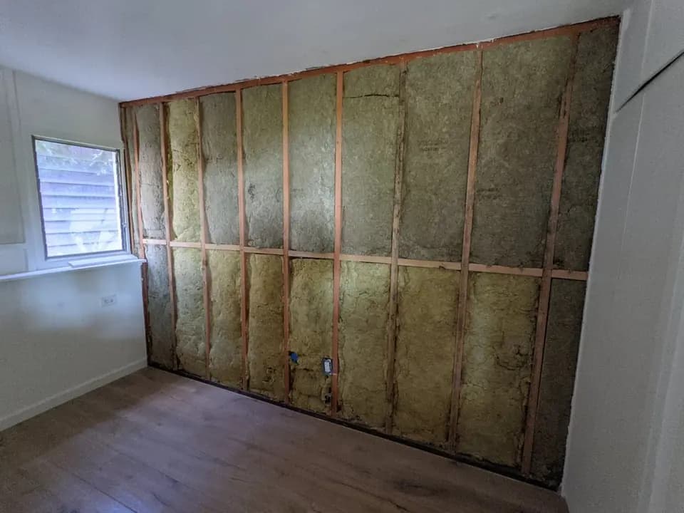 Wall cavities filled with acoustic mineral wool